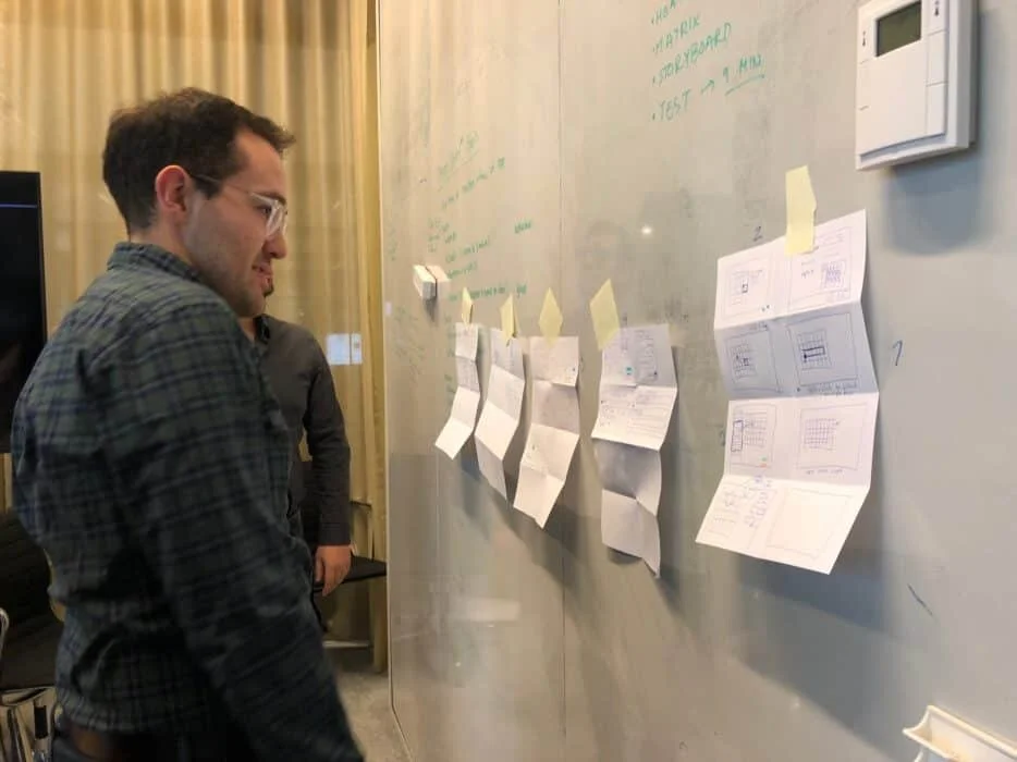 Team members reviewing and voting on sketches from crazy 8 exercise. IMG credit: Mendix, Inc.