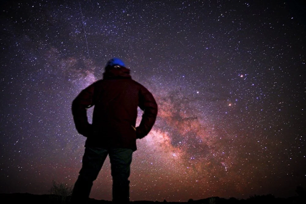 “A man looking up at the Milky Way and stars at Goblin Valley Road.” by  Greg Rakozy  on  Unsplash